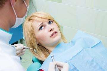 Anxious female patient in chair highlighting need for Dental Phobia Solutions