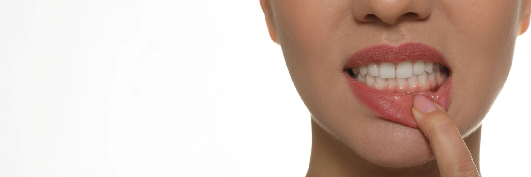 A blonde-haired woman smiles, reflecting the benefits of effective gum disease treatment.